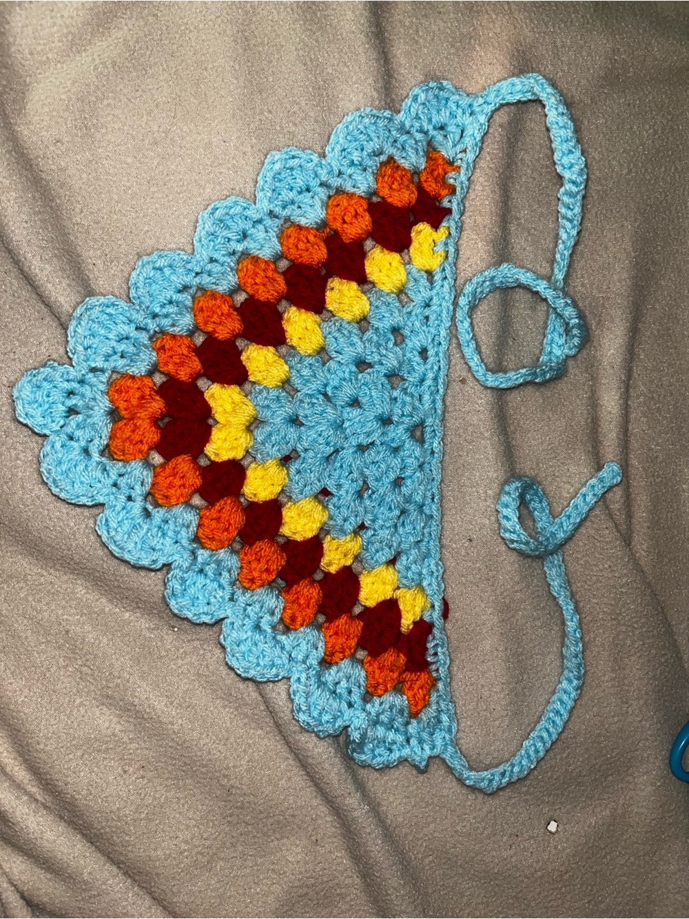 Handmade Crochet Triangle Bandana – Light Blue with Red, Orange & Yellow Accent